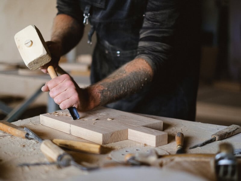 Man shaping wood with chisel